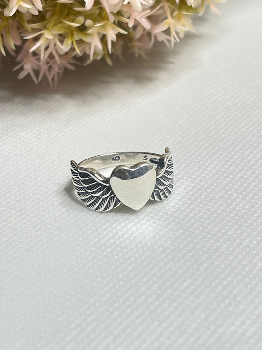 Heavenly Elegance: Angel Wings with Heart-Shaped Silver Ring - A Symbolic Embrace of Love and Grace